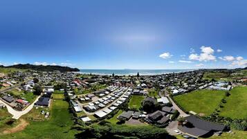 A coastal town with a marina, green spaces, and a mix of residential and commercial buildings.
