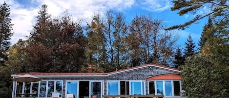 A two-story house with a covered patio and a fenced yard.
