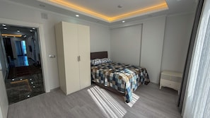 Apartment, Sea View | Desk, laptop workspace, blackout drapes, iron/ironing board