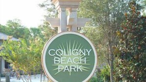 A sign for Coligny Beach Park with a circular design and a stone base. - Ocean Oriented Oasis!  Indoor Heated Pool!  Pickleball! Hot Tub! (Hilton Head)