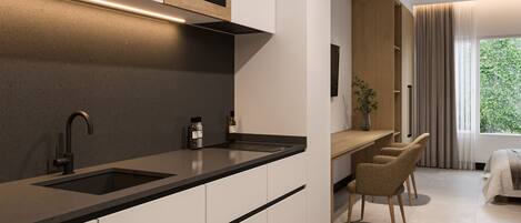 A modern kitchen with a built-in microwave, a sink, and a dining area with chairs.