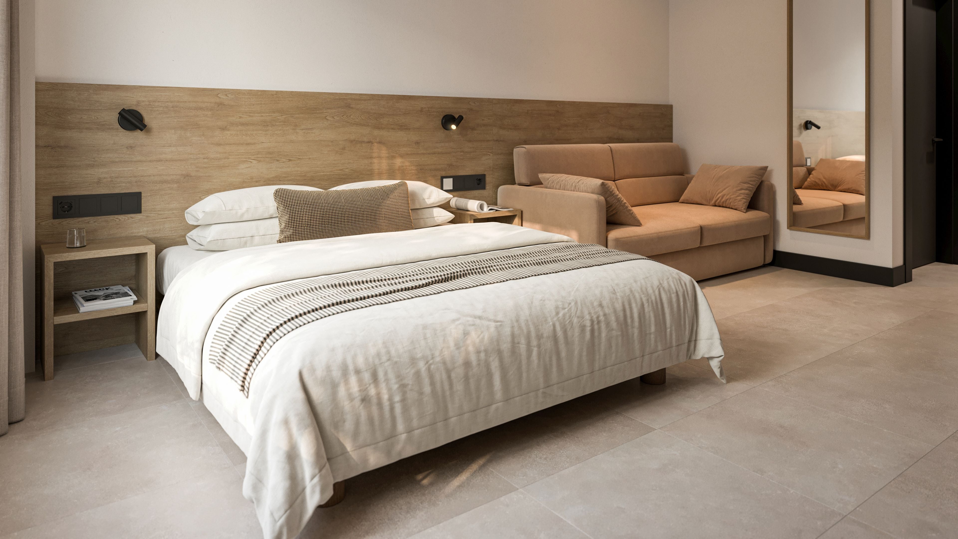 Un dormitorio moderno con una cama grande, una mesita de noche, una lámpara de lectura y un sofá.