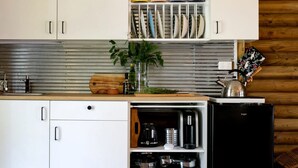 Coffee/tea maker, fridge, toaster, dining table