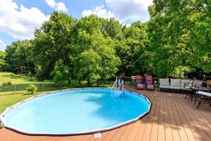 A swimming pool with a wooden deck, surrounded by trees. - Peaceful Historic Villa with Hot Tub & Pool near Downtown Nashville, Tennessee (Goodlettsville)