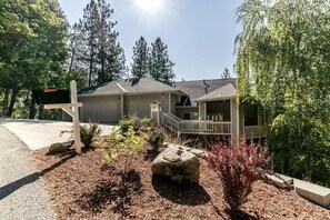 A two-story house with a front porch and a mailbox. - Enchanting Vacation Rental with Breathtaking Lake Views near Lake Fernan in Idaho (Coeur d'Alene)