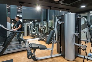A gym with treadmills, weight machines, and a mirrored wall. - Student Only Verde Newcastle (Newcastle upon Tyne)