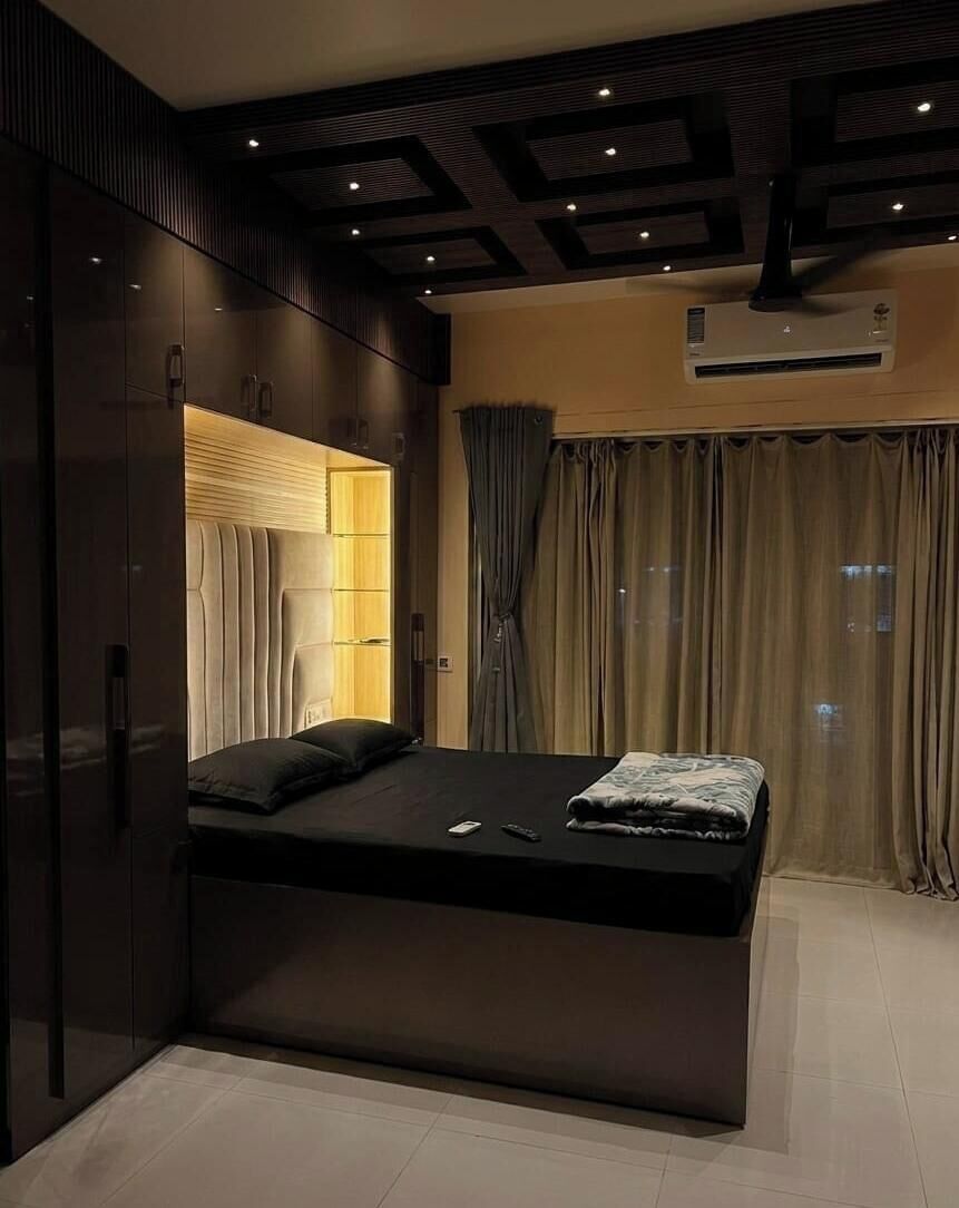 A modern bedroom with a bed, built-in wardrobe, and a window with curtains.