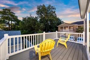 A wooden deck with white railings and two yellow chairs. - Pier View Home Sleeps 10 Pet Friendly (Myrtle Beach)
