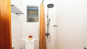 A small bathroom with a shower, toilet, and a small window. - Tranquil 2-bedroom apartment in welcoming Nairobi neighborhood (Nairobi)