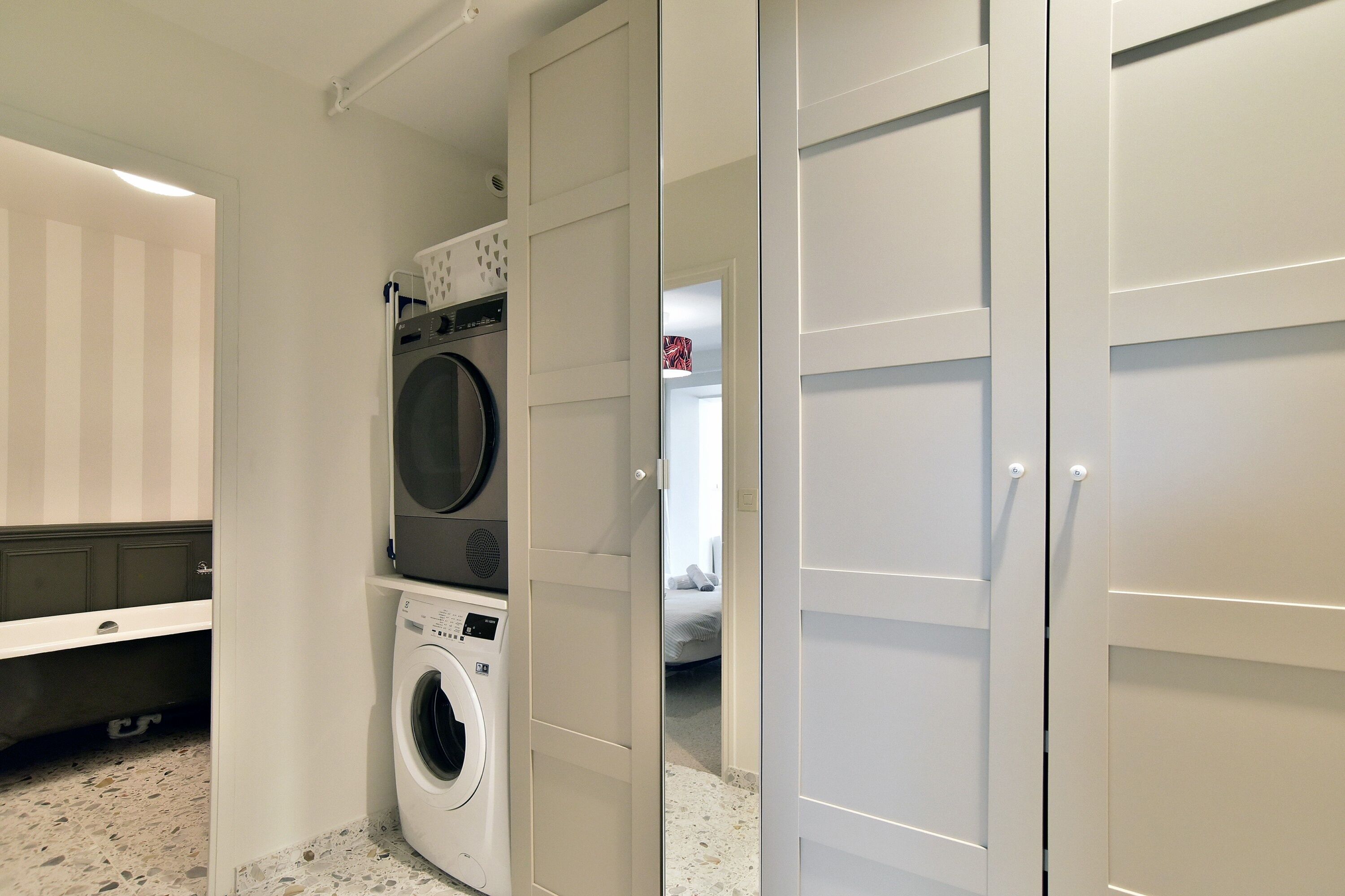 A laundry room with a washing machine and dryer, a utility sink, and a countertop.