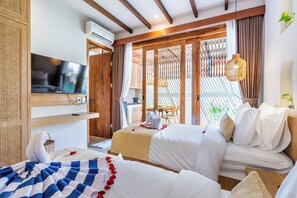 A hotel room with two beds, a TV, a wooden ceiling, and a view of the outdoors. - Amartya F19 (Ubud)