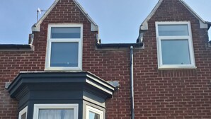A brick house with a bay window, a white door, and a number plate. - Alice Place (Sunderland)