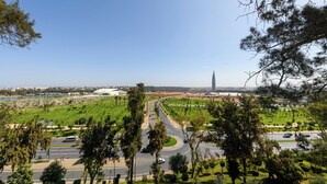 A cityscape with a prominent tower, a roundabout, and a large open park area.