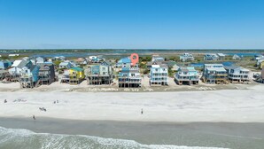 A coastal area with beachfront houses, a sandy beach, and waves approaching the shore. - Peaceful Pearl (North Topsail Beach)