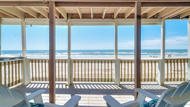 A beachside wooden deck with white chairs and a view of the ocean. - Peaceful Pearl (North Topsail Beach)