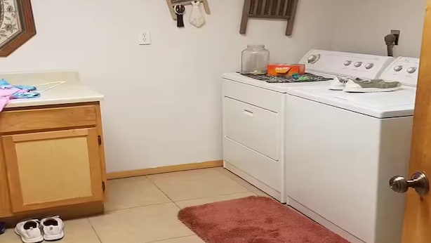 A laundry room with a washing machine, dryer, and a cabinet with shoes. - River Retreat (Valliant)