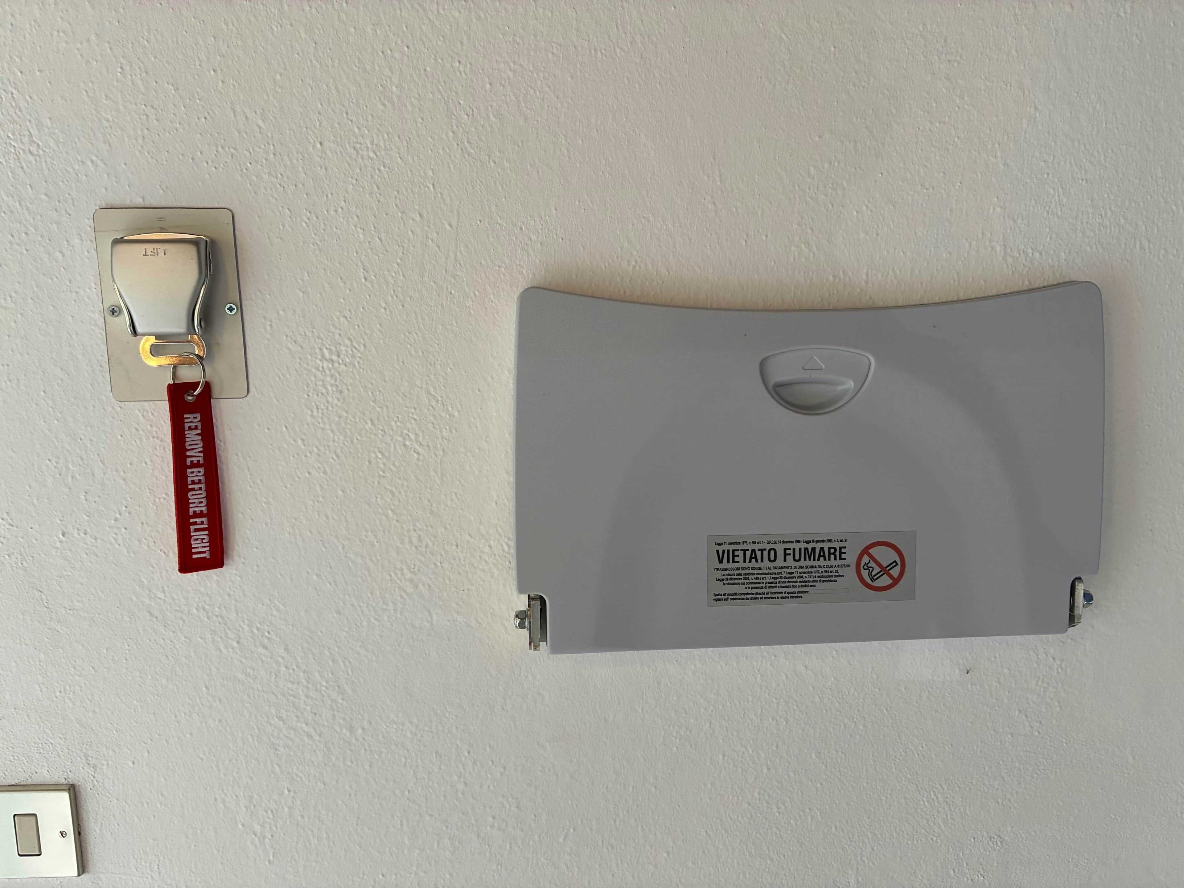 A wall-mounted light switch and a fire safety sign.