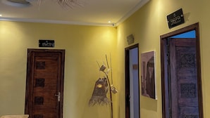 Un pasillo con suelo estampado, techo decorativo y puertas de madera con diseños geométricos.