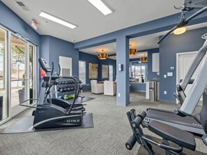 A gym with treadmills, a stationary bike, and a weight machine. - 2BR/2BA Luxury | Walkable + Parking | PET Friendly (Charlotte)