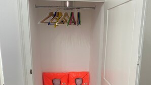 A closet with a hanging rod and two orange life jackets. - Apartment 'Touristhouse Monopoli 10' with Balcony, Wi-Fi and Air Conditioning (Monopoli)