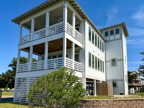 A two-story building with a balcony on the upper level and a separate section on the lower level.