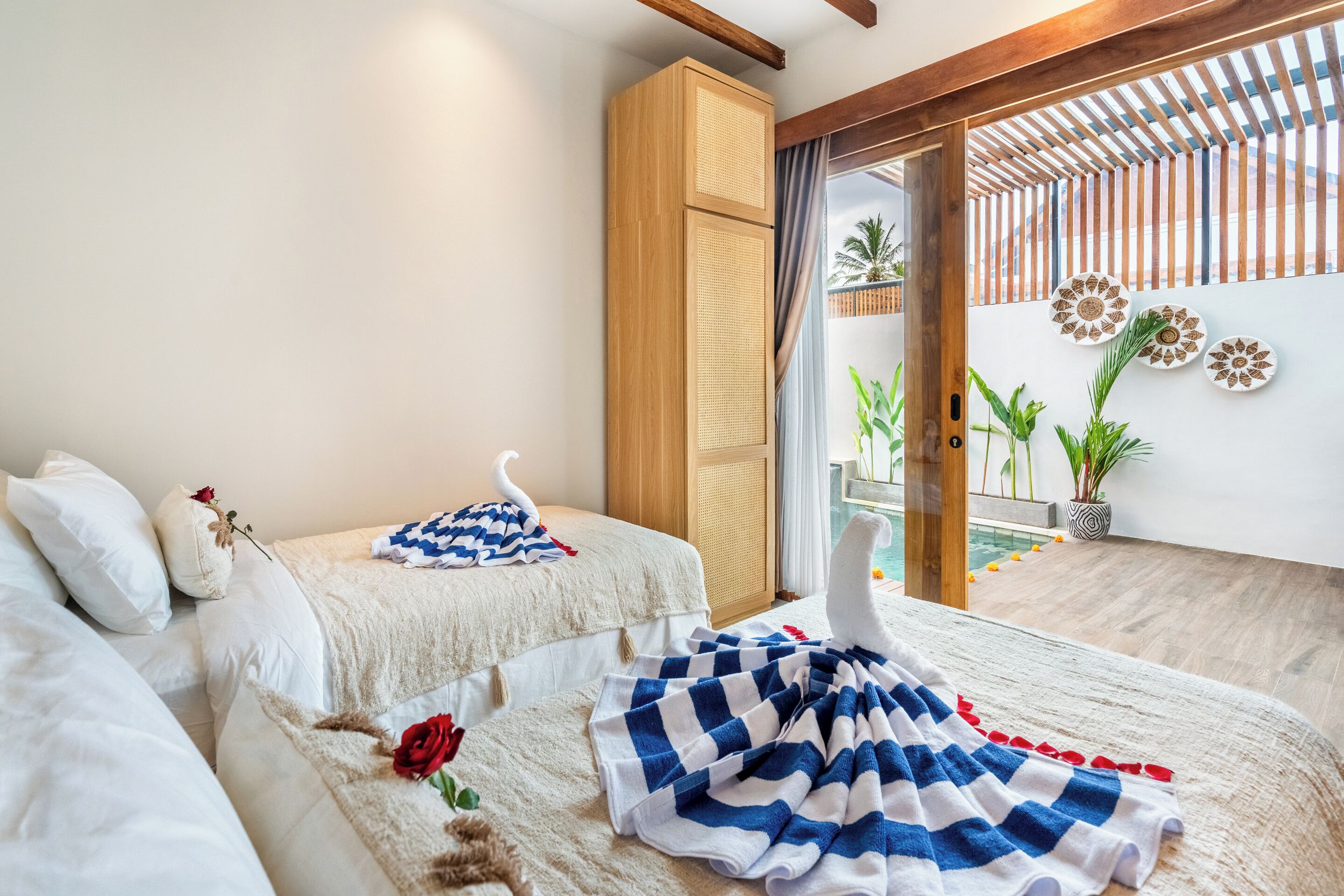 A bedroom with a bed, a wardrobe, a window with a view, and a decorative wall.