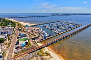 A coastal marina with boats, a bridge, and a train track. - Caron House - Bay St. Louis (Bay St. Louis)