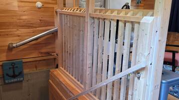 A wooden staircase with a handrail, a wooden fence, and a sign that reads 'The sea anchors my soul.'