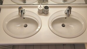 A bathroom with two sinks, each with a faucet and a mirror above. - Comfortable apartment—5-minute walk to the RER An at Busy-Saint-Georges—8 minutes to Disney. (Bussy-Saint-Georges)