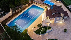 A residential property with a tennis court, swimming pool, and landscaped garden. - California Dream Luxury Villa (Poljica)