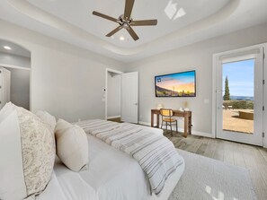 A bedroom with a bed, a desk, and a view of the outdoors. - Golden Eagle Fountain Hills (Fountain Hills)