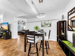 A modern dining area with a table, chairs, and a ceiling light fixture. - Southern #1083 Mesa (Mesa)