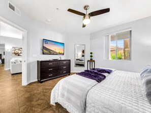 A bedroom with a bed, a TV, a ceiling fan, a dresser, and a window. - Southern #1083 Mesa (Mesa)