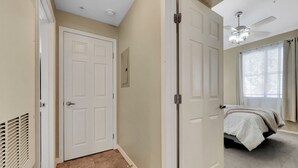 A bedroom with a bed, a ceiling fan, and a window with curtains. - Southern #2059 Mesa (Mesa)