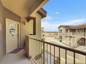 A residential building with a beige exterior, a welcome sign, and a balcony with a metal railing. - Southern #2059 Mesa (Mesa)