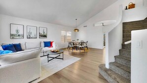 A modern living room with a sofa, coffee table, and artwork on the wall. - Delta Mesa (Mesa)