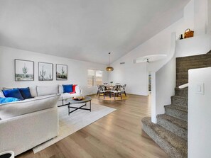A modern living room with a sofa, coffee table, and artwork on the wall. - Delta Mesa (Mesa)
