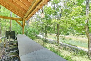 An outdoor seating area with a view of a river and forest. - Fish and Swim: Home w/ Catskill Creek Views! (East Durham)