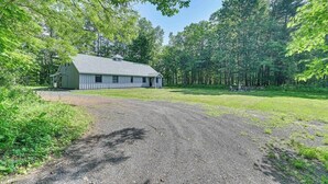 A single-story building with a gravel driveway leading to a grassy area. - Fish and Swim: Home w/ Catskill Creek Views! (East Durham)