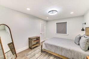A bedroom with a bed, a wardrobe, a mirror, and a window. - Fish and Swim: Home w/ Catskill Creek Views! (East Durham)