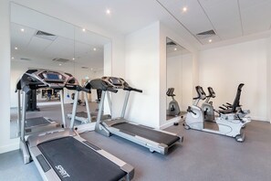 A gym with treadmills, ellipticals, and stationary bikes. - Student Only Print Hall (Underpass)