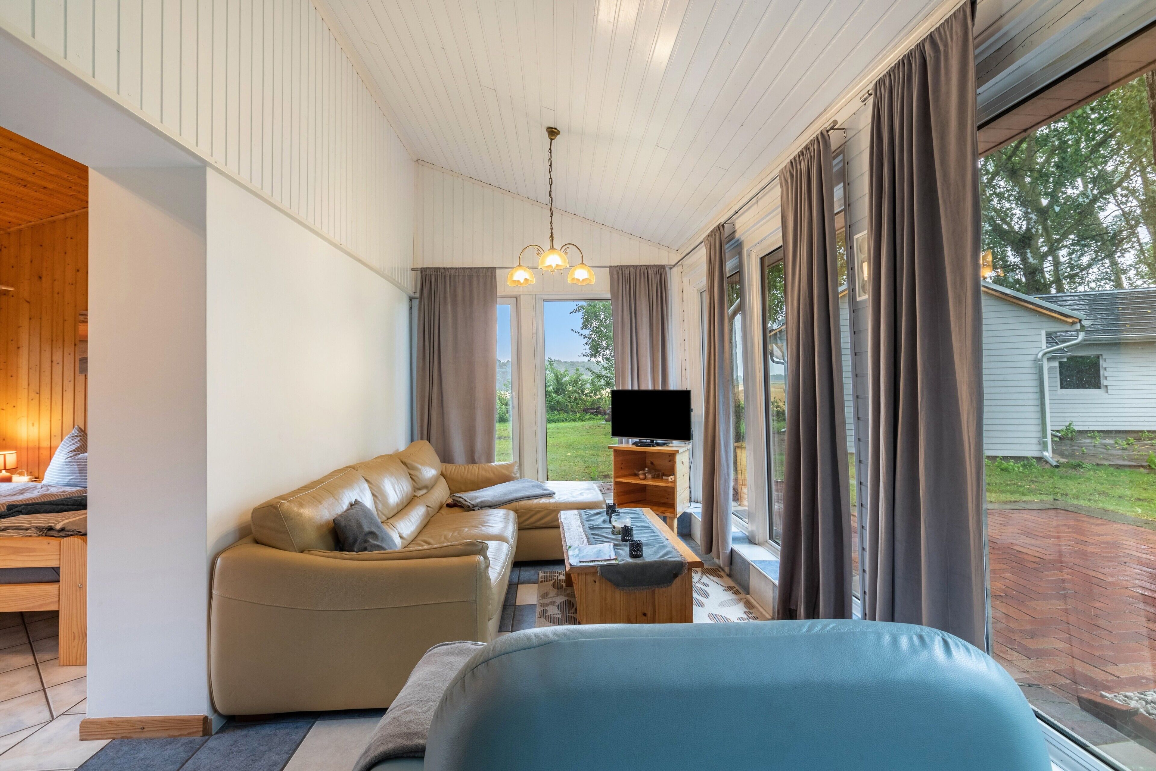 A modern living room with a sofa, a coffee table, and a TV.