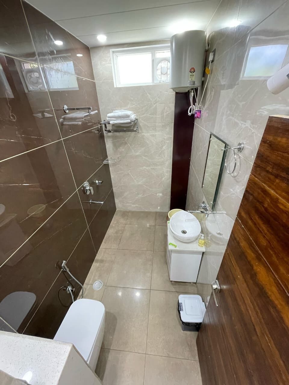 A modern bathroom with a toilet, sink, and shower.