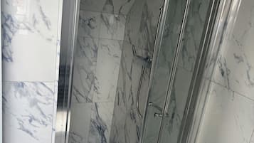 Een douche, een haardroger, handdoeken, toiletpapier