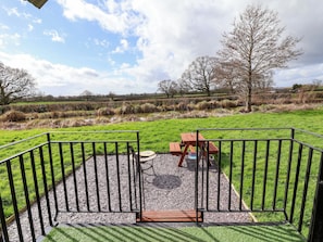 A park with a picnic table and a metal fence. - Quackin' Up (Whitchurch)