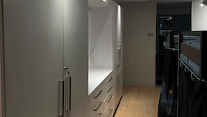 A modern interior with a wardrobe, a closet, and a bed with a headboard. - Smith's Irish Pub & Accomodation (Vancouver)