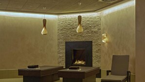 A modern lounge area with a fireplace, two seating areas, and a single armchair. - 2 Person Holiday Park Home in Friedrichroda OT Finst (Friedrichroda)