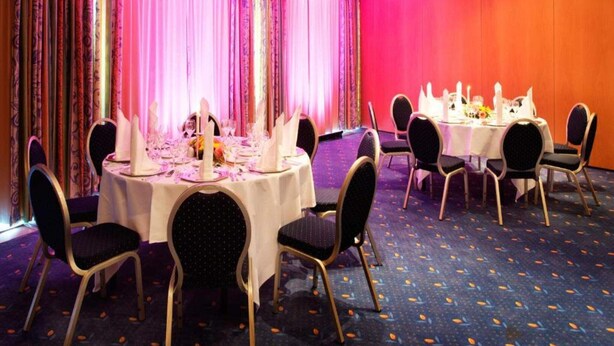 A banquet hall with round tables set for dining, chairs, and a carpeted floor. - 2 Person Holiday Park Home in Friedrichroda OT Finst (Friedrichroda)