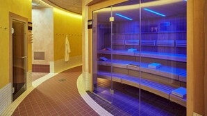 A sauna with glass walls and benches, a tiled floor, and a yellow wall. - 2 Person Holiday Park Home in Friedrichroda OT Finst (Friedrichroda)
