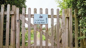 A wooden gate with a sign for Canal Walk & Dog Wash. - Foxes Den (Whitchurch)